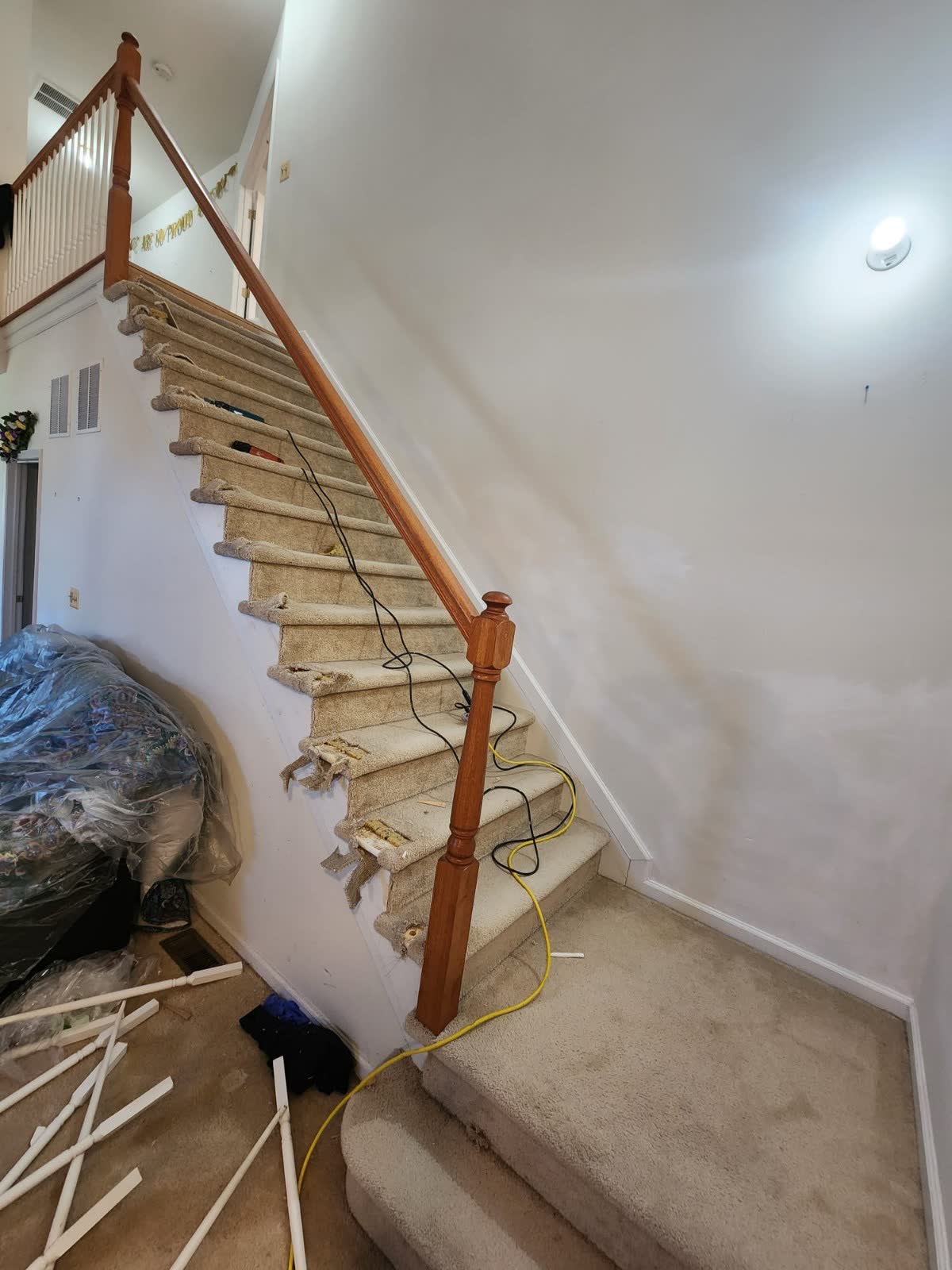 Carpet removed from stairs before new hardwood tread installation in New Jersey